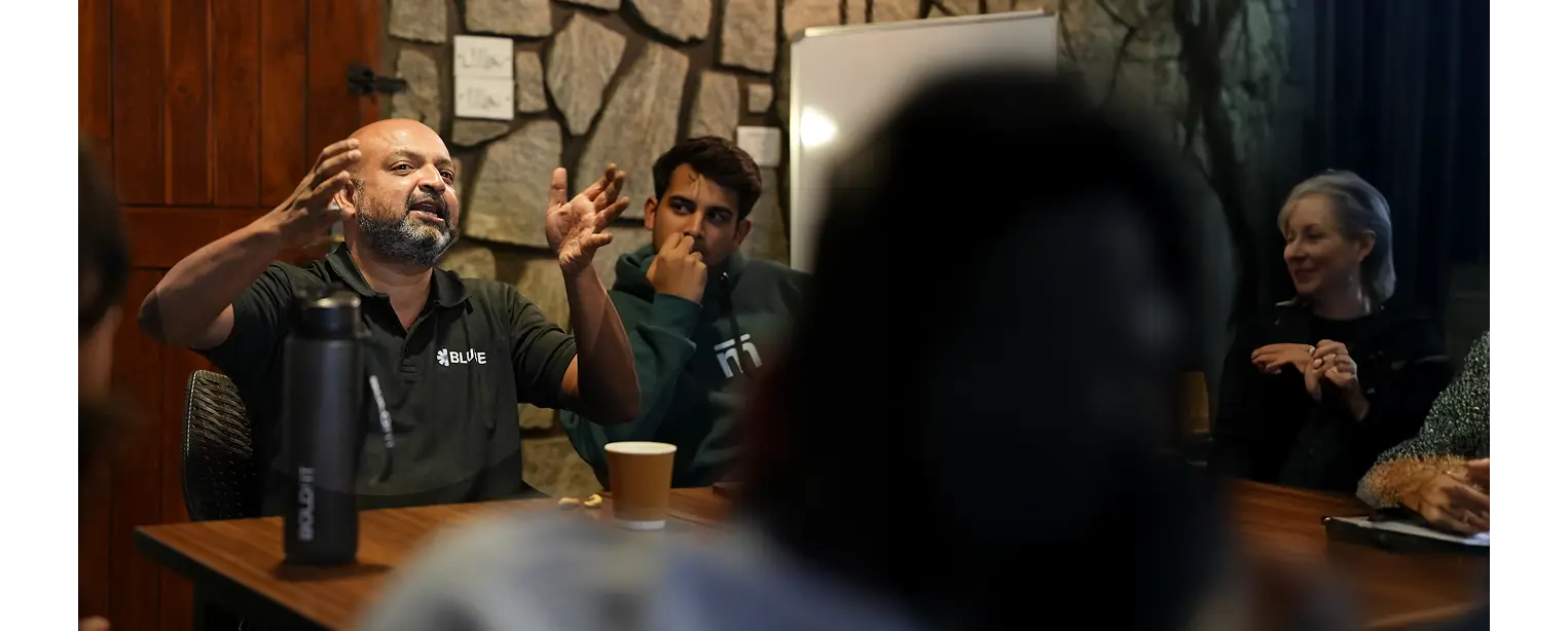 An investor session with the cohort around the table on campus