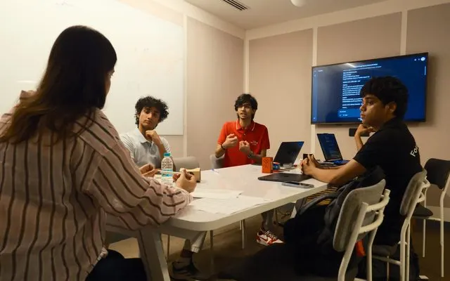 A student team pitching their AI solution in a client-style meeting