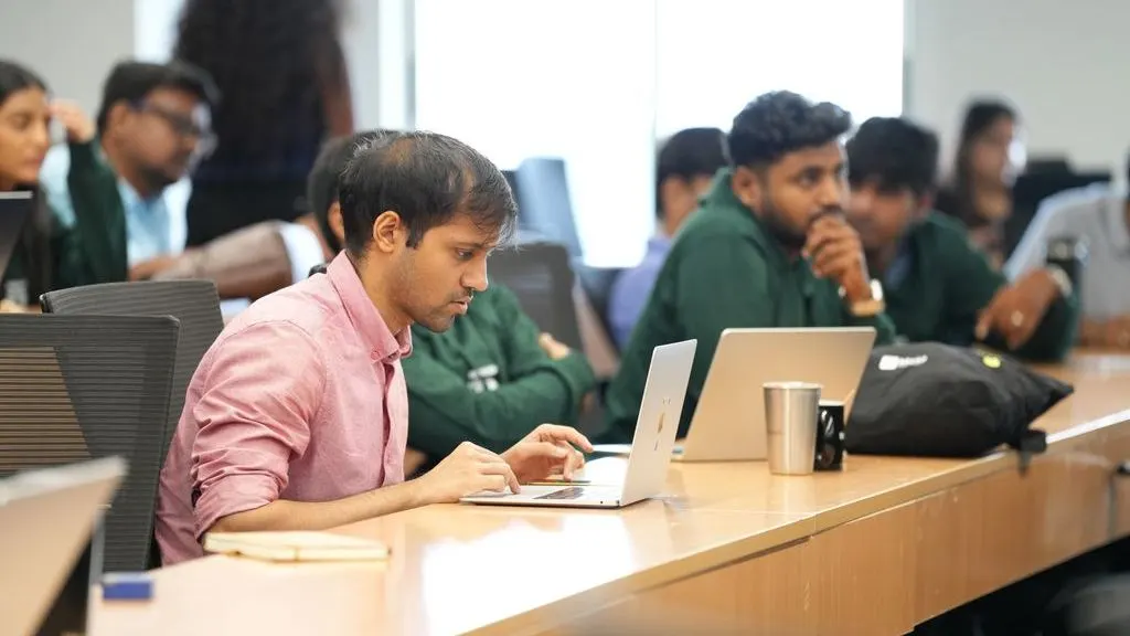 Students working on laptops during an AI session at Mesa