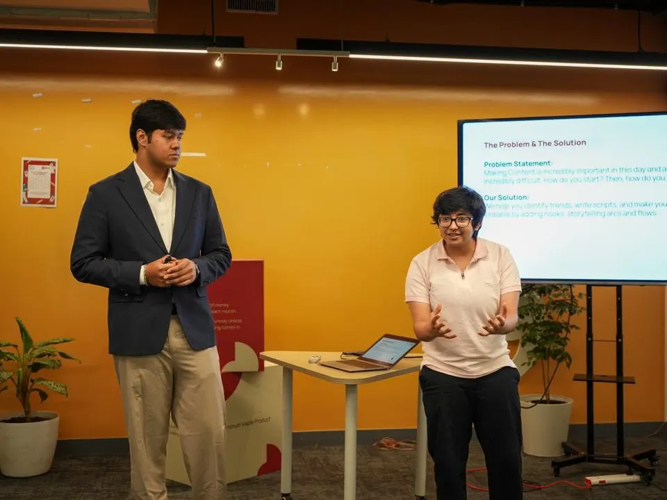 Two students presenting the problem and solution behind their product