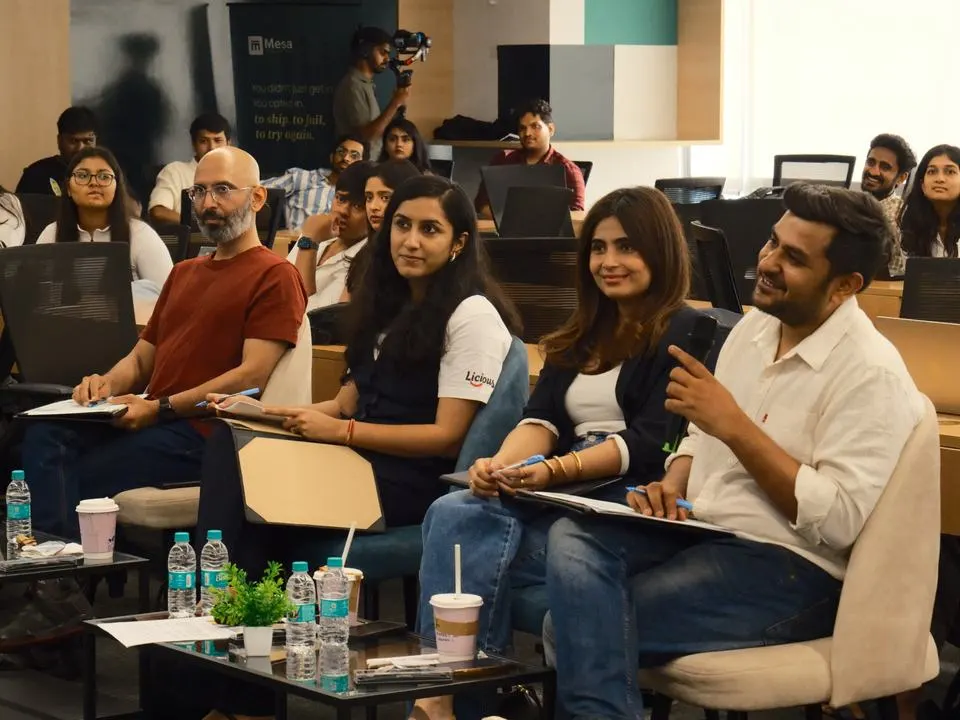 A panel of founders reviewing student work at Mesa