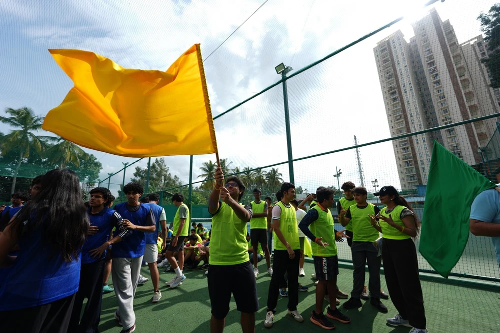 Students waving team flags at Mesa sports day