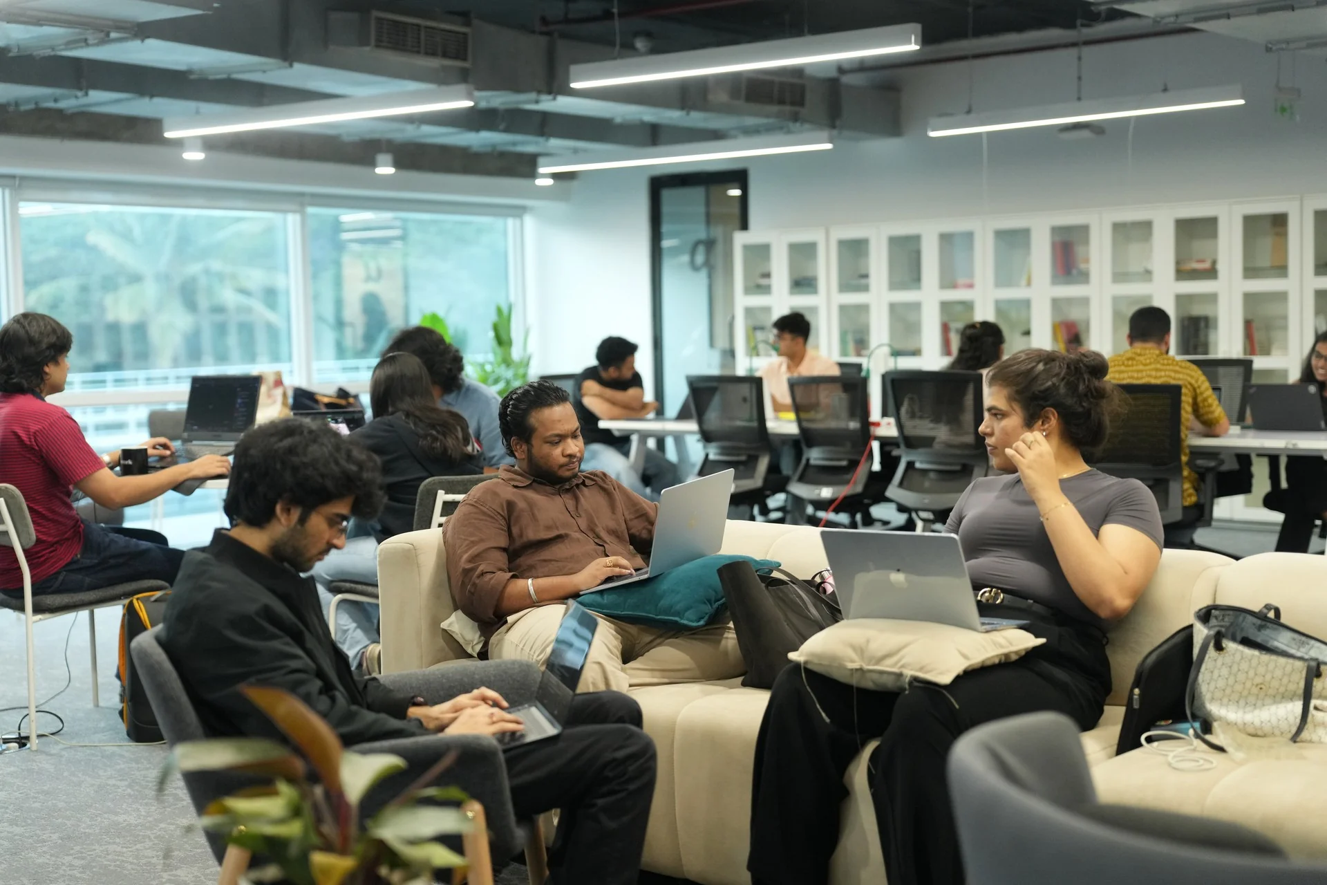 Students working on laptops on the lounge sofas