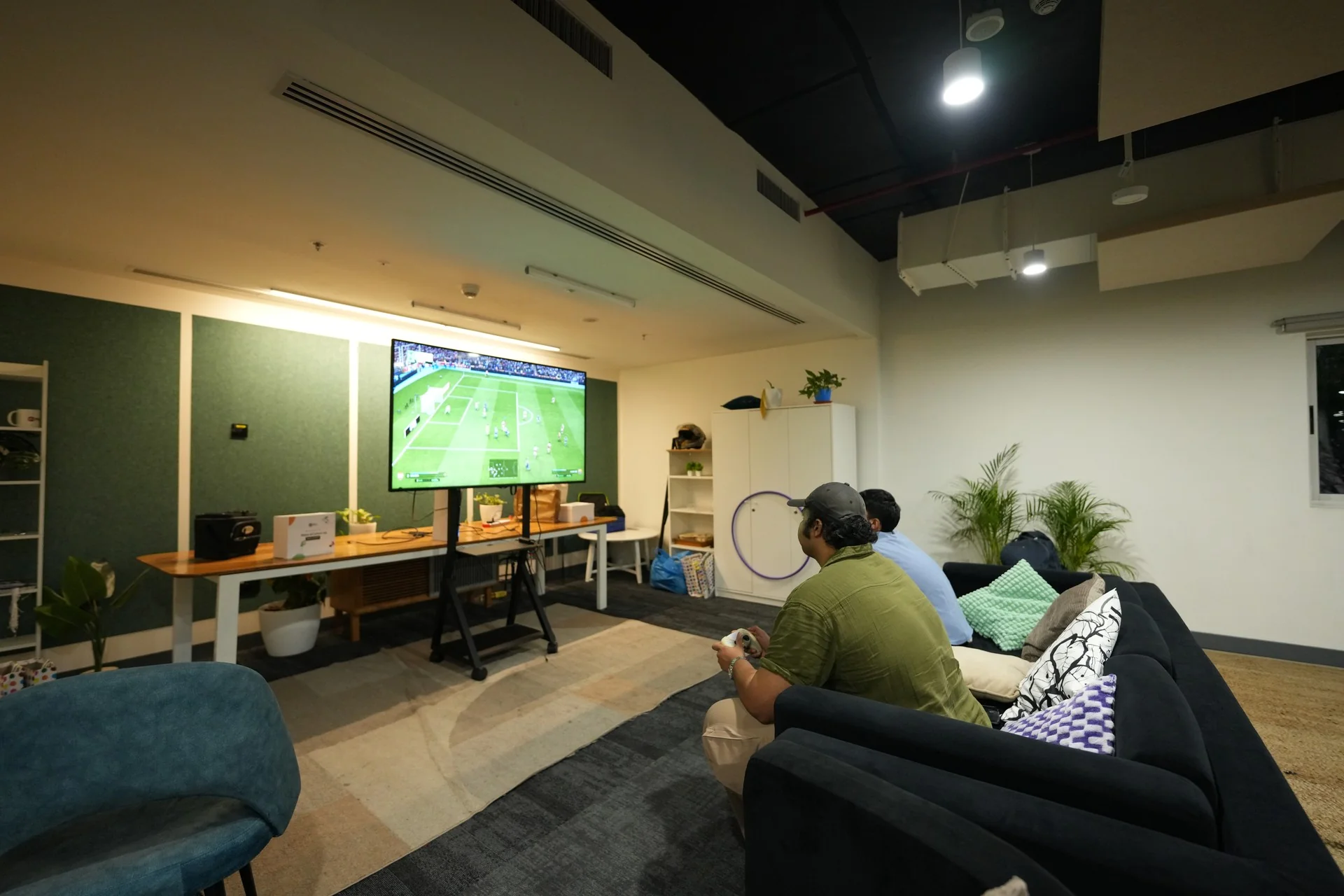 Students watching a match on the TV in the lounge