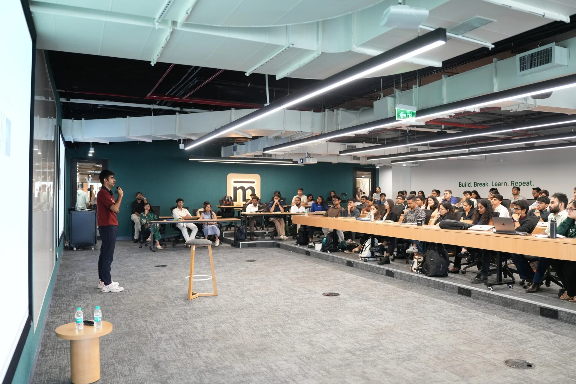 A speaker addressing the full class in the Mesa classroom