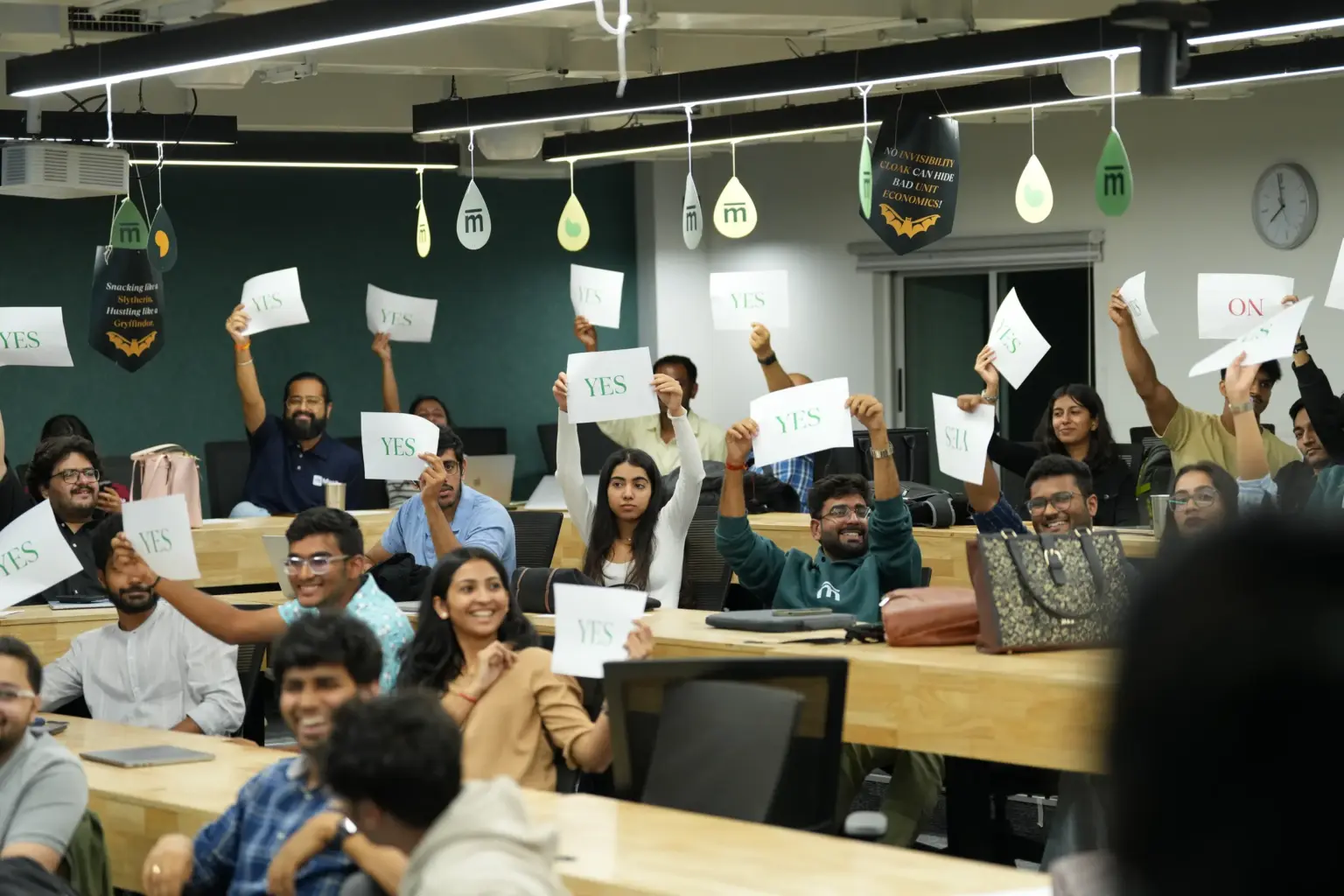 Students holding up YES and NO cards during a class at Mesa School of Business