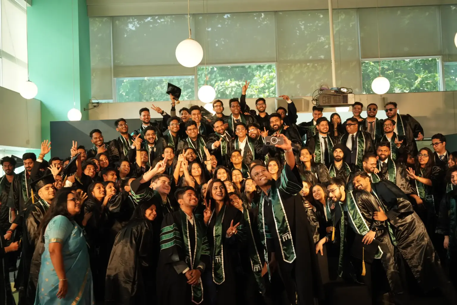 A graduating Mesa School of Business cohort in caps and gowns