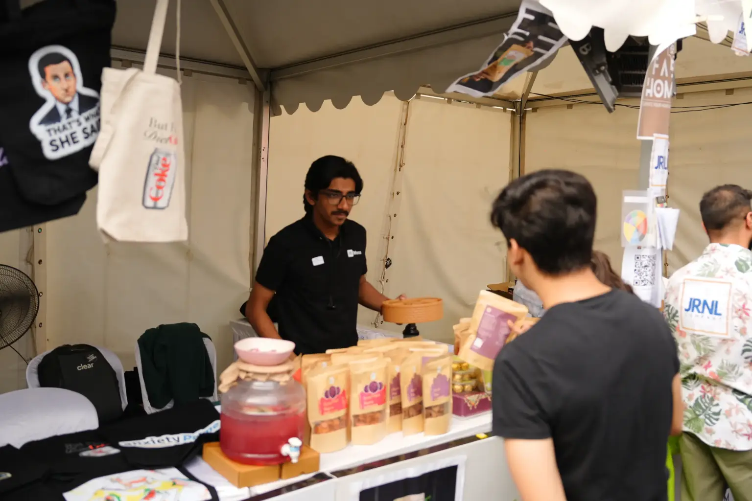 A Mesa School of Business student selling products at a market stall