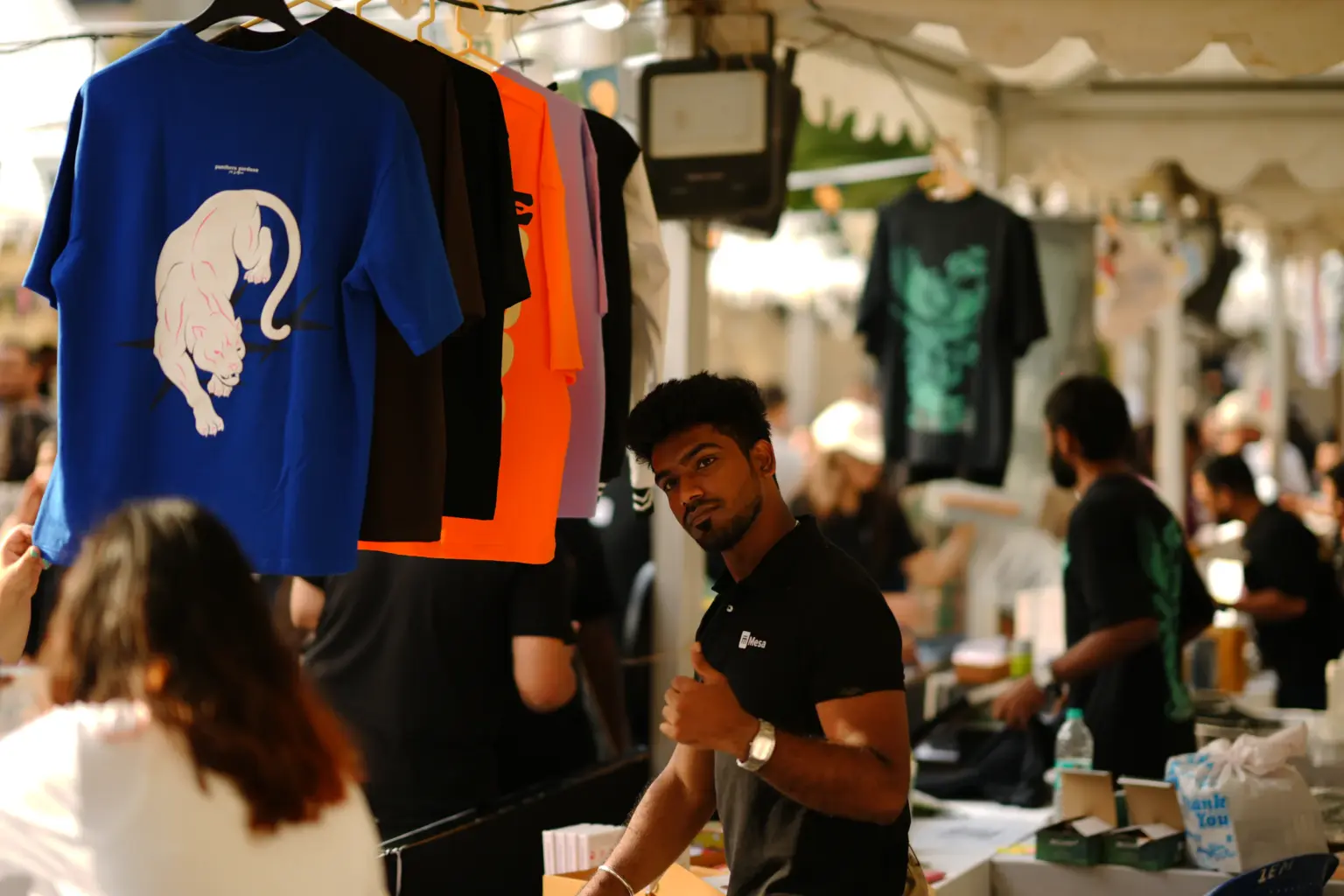 A Mesa School undergraduate student at an apparel stall during Build Your Own Business